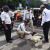 Mumbai Rain Live: Traffic cops filled potholes to avoid accidents at Shreyas Junction in Ghatkopar, Mumbai, on Tuesday.
