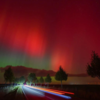 Aurora borealis glowing above a road