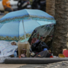 Woman sleeping on corniche
