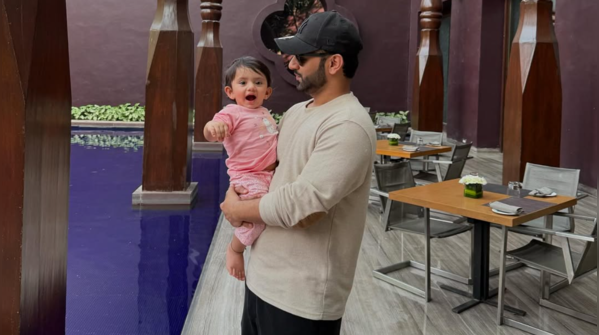 Little Navya all amazed in father’s arms