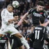 Kylian Mbappé Heads the Ball During Champions League Quarterfinals Match Between Real Madrid and Arsenal