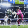 Arsenal's Goalkeeper David Raya Makes a Save in Champions League Quarterfinals Match