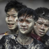Thai People Celebrate Songkran Water Festival with Painted Faces in Prachinburi