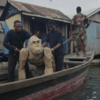 Cardboard gorilla floats through Makoko