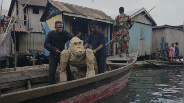 Cardboard gorilla floats through Makoko