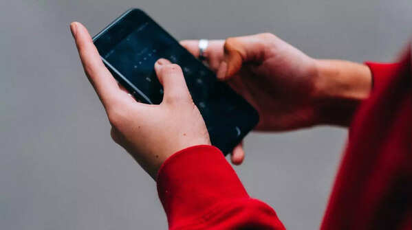 Using both hands and thumbs to hold the phone