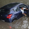 Floodwaters engulf car