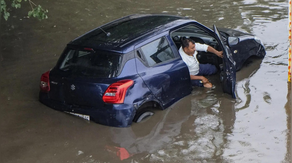 Floodwaters engulf car