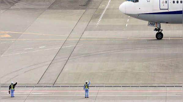 Ground staff bids goodbye to departing aircraft