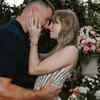 Taylor Swift holding Travis’s face in her hands