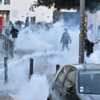 Protesters throw objects; police retaliate with tear gas