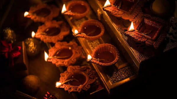 Traditional elements: Diyas, rangoli and floral garlands