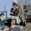 Black flags, portraits displayed