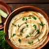 A small bowl of cucumber and hummus