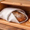 Wrap bread in cloth and store in a bread box