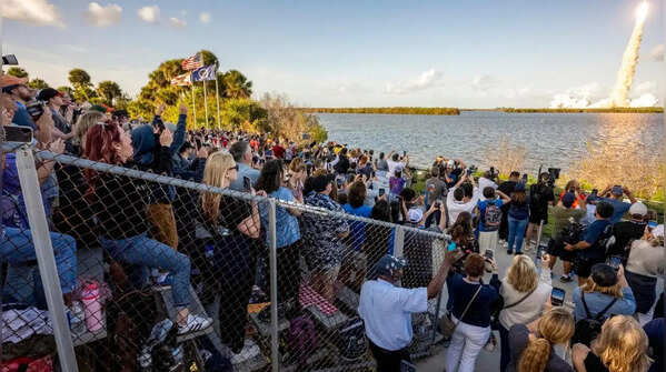 Onlookers gather to photograph and celebrate this historic moment.