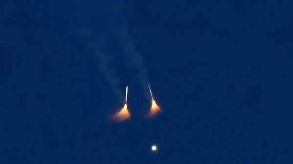 Rocket boosters on Nasa's Artemis II moon rocket fall away after lifting off.
