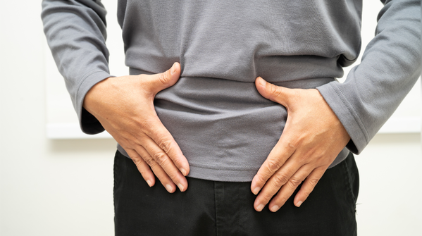 A heavy or swollen feeling in the abdomen