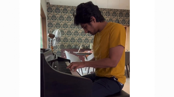 Piano set on a damask wallpaper