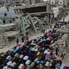 People offering prayers amidst ruins