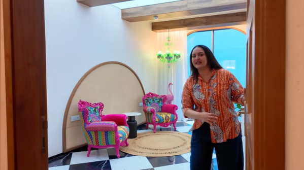 Flamingo-inspired bright pink chairs in a boho-themed room