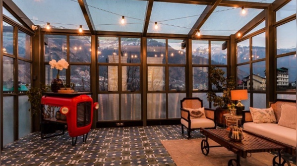 Glass house with a scenic mountain terrace view