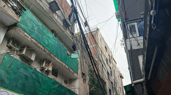 Tangled electrical lines loom over homes