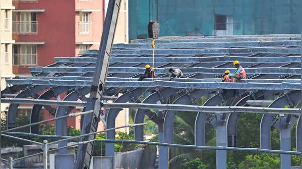 Workers focus on roofing section of elevated metro corridor