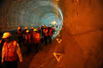 Workers walk through under contruction tunnel that will soon have metro trains running through it.
