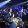 Dave Grohl walks through the audience with a bass drum at the Grammys