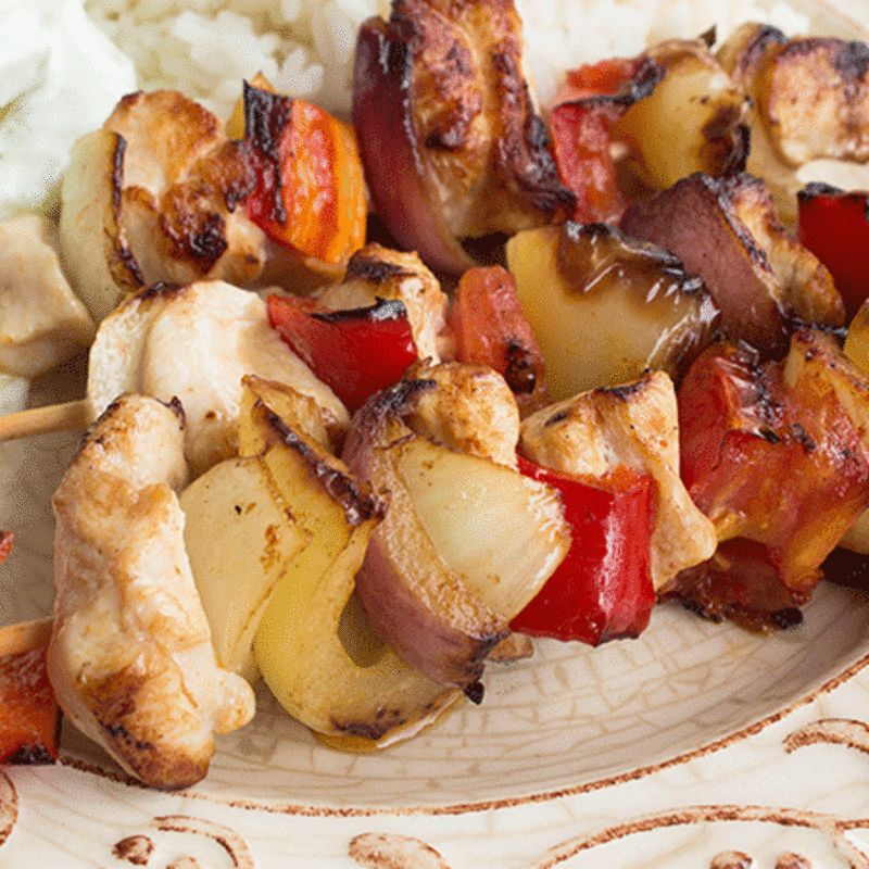 Marinated barbecue meat on skewer. Shish kebab or Shashlyk meaning skewered  meat. Beef or pork on grill on an open fire. Street food, picnic concept  Stock Photo