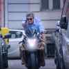 Ajith speeding off in a bike