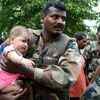 An army personnel rescuing a baby in flood-hit Nagaon district in Assam