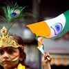 A child dressed up like lord Krishna holding Indian National flag during celebrations to mark the festival of Janmashtami in Mumbai.