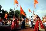 Women with saffron flag during a visarjan procession in Pune