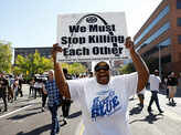 A woman holds a sign outside the St. Louis Metropolitan Police Department
