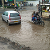 Commuters had a tough time in negotiating on waterlogged roads in Velachery locality.