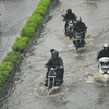 Locals struggle through a waterlogged road in Chennai.