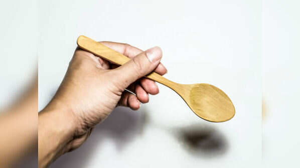 Holding spoon in the wrong hand