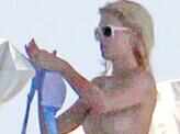 Paris Hilton goes topless on a trip