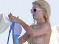 Paris Hilton goes topless on a trip
