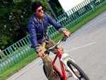 Shah Rukh Khan rides a cycle on the sets of the movie