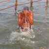 Article image for: A devotee taking <i class="tbold">holy dip</i> at sangam on makar sankranti