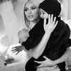Saint sitting pretty in Kim's arms