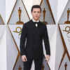 Tom Holland arrives at the Oscars red carpet.