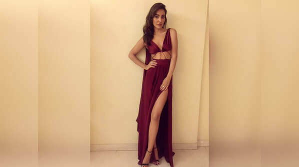 Neha channels her inner diva in a maroon thigh-high slit gown