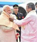 Modi greets Siddaramaiah with a laugh