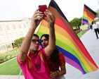 Parmesh Shahani and Nitasha Biswas attend a pride parade