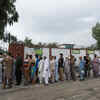 People stand in queue as they wait for a polling station to open in Rawalpindi