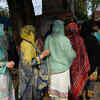 Women stand in a queue before casting their votes at a polling station in Lahore.